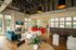 Modern and inviting common area with high ceilings, stylish seating, and natural light, featuring a cozy fireplace and a vibrant coffee bar.