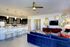 Modern open-concept living space with a chic kitchen, stylish lounge area, and elegant decor, perfect for entertaining.