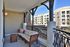 Charming balcony with stylish seating and views of modern architecture, perfect for relaxation.