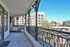 Charming balcony view overlooking a lively neighborhood with comfortable seating, perfect for relaxation and cityscaping.