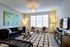 Elegant living room featuring chic modern design with stylish furniture, warm lighting, and artistic decor.