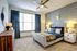 Elegant bedroom with stylish decor, featuring a plush bed, modern nightstands, and soft natural light filtering through large windows.