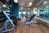 Modern fitness center with state-of-the-art equipment, featuring sleek dumbbells, exercise balls, and bright, inviting lighting.