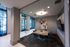 Modern conference room with sleek glass walls, stylish lighting, and contemporary decor, perfect for productive meetings.