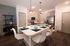 Modern kitchen with sleek countertops, stylish pendant lighting, and cozy breakfast bar seating.