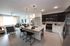 Modern open-concept apartment with sleek kitchen island, stylish living area, and chic pendant lighting.