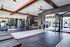 Modern and spacious fitness center featuring state-of-the-art gym equipment, sleek design, and ample natural light.