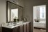 Sophisticated bathroom with double vanity leading to a serene bedroom, offering a blend of elegance and comfort.