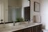 Elegant bathroom featuring a dual-sink vanity, modern glass shower, and sophisticated decor.