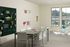 Bright and inviting creative workspace with large windows, modern furniture, and organized craft supplies.