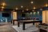 Chic entertainment lounge with stylish billiards and foosball tables, modern seating, and ambient lighting.
