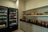 Inviting snack room with well-stocked refrigerators and shelves filled with a variety of beverages and tasty treats.