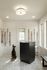 Bright and inviting pet-friendly room with elegant dog leashes and a cozy chair, featuring a unique patterned floor and natural light.