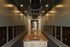 Modern and elegant mailroom with sleek design, featuring sophisticated lighting and numerous mailboxes for convenience.