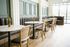 Chic and cozy cafe interior with elegant marble-topped tables, stylish seating, and bright natural lighting.