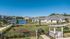 Serene lakeside community with modern apartments, lush greenery, and a convenient dog wash area, perfect for comfortable living.
