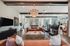 Elegant open-concept living area with stylish chandeliers, cozy seating, and natural light highlighting modern decor.