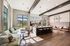 Chic modern kitchen and lounge with large windows, elegant seating, and stylish lighting, offering a bright and inviting atmosphere.