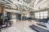 Modern fitness center with state-of-the-art equipment, sleek design, and ample natural light.