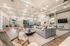 Spacious and elegant open-concept living area featuring modern decor, a plush sectional sofa, and stylish lighting, perfect for entertaining.