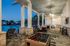 Elegant outdoor entertainment area with cozy seating, foosball table, and inviting poolside ambiance at dusk. Perfect for relaxation and social gatherings.
