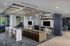 Modern lounge area with elegant ceiling design, cozy sofa, dual TVs, and sleek marble bar seating, perfect for relaxation and entertainment.