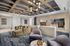 Stylish modern lobby with elegant seating, plush carpet, and artistic decor accented by contemporary lighting and ceiling design.