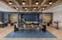 Elegant and modern communal space featuring a stylish coffered ceiling, chic seating arrangements, and a sophisticated tiled accent wall, perfect for socializing and relaxation.