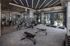 Modern gym featuring state-of-the-art fitness equipment, sleek design, and stunning window views.