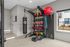 Modern home gym with professional punching bag, vibrant medicine balls, kettlebells, and workout bands, offering a sleek fitness space with natural light.