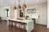 Modern kitchen with elegant marble island, stylish pendant lights, and sleek cabinetry ideal for entertaining.