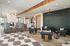 Modern, inviting lounge area featuring sleek chairs, stylish decor, and a cozy fireplace, perfect for social gatherings or relaxation.