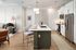 Modern open-concept kitchen and living room with sleek appliances, a stylish island, and cozy seating, perfect for entertaining.