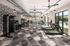 Modern fitness center with diverse equipment, large windows overlooking a pool, and stylish geometric flooring.