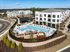 Modern apartment complex with a large, inviting swimming pool, stylish lounge area, and beautifully landscaped surroundings.