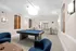 Inviting recreation room with a modern pool table, comfortable seating, and stylish lighting, perfect for entertainment and relaxation.