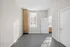 Bright and inviting room with modern neutral walls, large window with blinds, and sleek doors, perfect for personalization.
