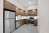 Contemporary kitchen with sleek stainless steel appliances, elegant wood cabinetry, and stylish white tile backsplash, ideal for modern living.