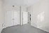 Bright and airy bedroom featuring sleek white closet doors and soft neutral walls, ideal for a peaceful retreat.