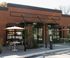 Charming coffee shop with outdoor seating and an electric vehicle charging station.