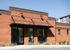 Charming pet center with modern exterior, featuring striking red brick and sleek black accents under a clear blue sky.