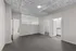 Modern open space with sleek gray carpeting, a bright airy atmosphere, and a contemporary ceiling design.