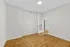 Bright and airy room featuring pristine wood flooring and sleek white walls, perfect for a personalized touch.