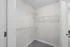 Bright and spacious walk-in closet with sleek wire shelving for optimal organization.