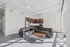 Modern apartment living room with sleek leather sofas, a chic wooden coffee table, and a contemporary kitchen featuring stainless steel appliances.