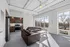 Modern open-concept apartment with stylish kitchen, sleek stainless steel appliances, and floor-to-ceiling windows offering a bright, airy living space with stunning views of the city.