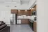 Modern kitchen with sleek stainless steel appliances, stylish wooden cabinets, and elegant lighting creating an inviting atmosphere.