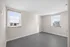 Bright, spacious room with large windows and modern finishes, offering stunning city views.