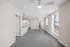 Bright, modern apartment interior with open-concept layout, featuring large windows and elegant lighting fixtures.