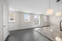 Bright and airy apartment with modern granite countertops, sleek pendant lighting, and large windows offering ample natural light.
